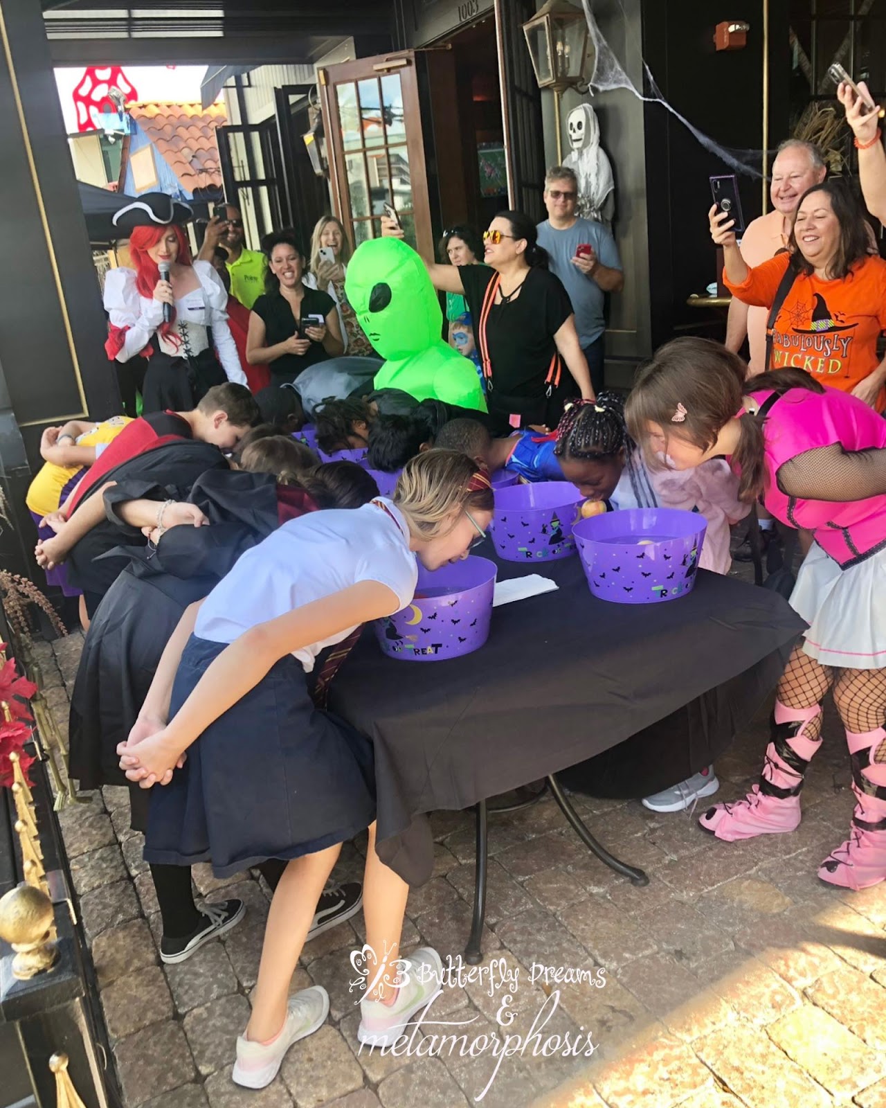 Kids bobbing for apples at The Pub Orlando’s PubKin Fest