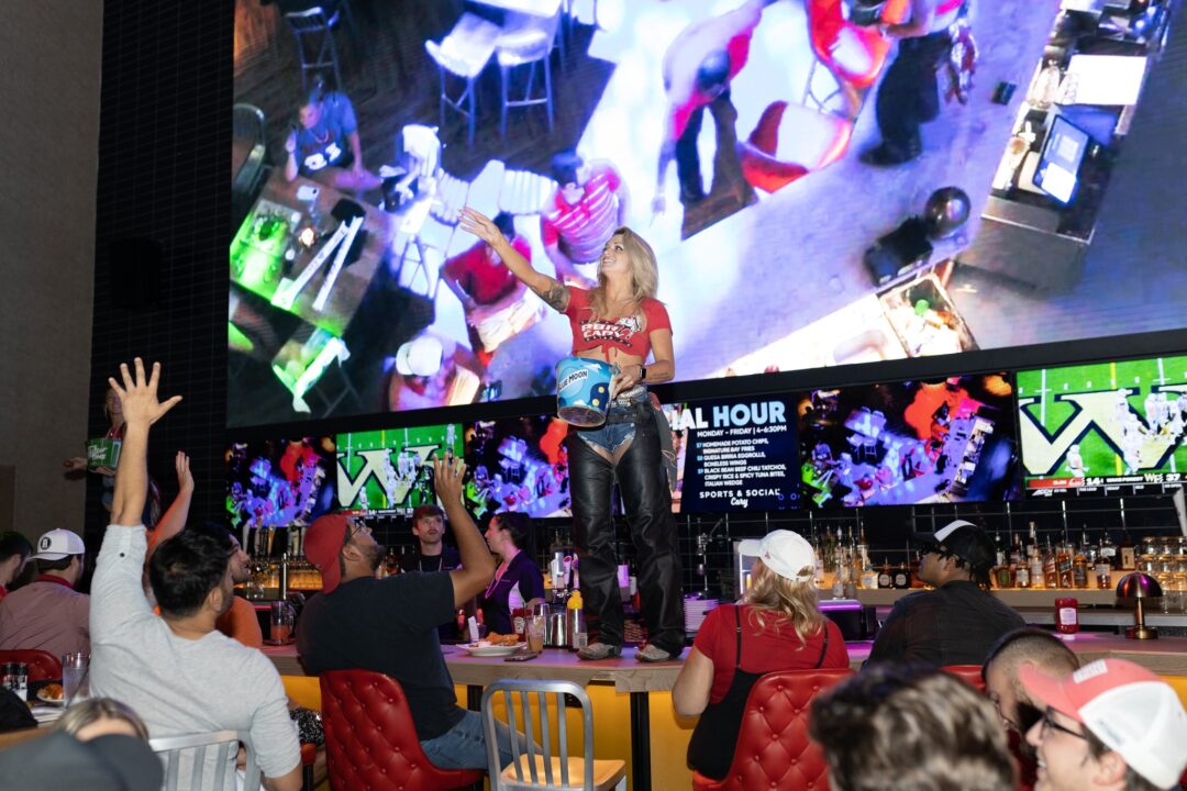 Photo of women throwing giveaways to restaurant customers